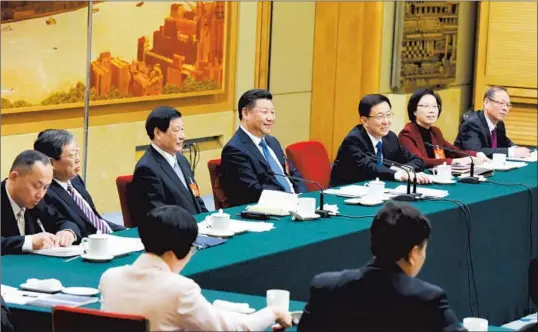  ?? — Chen Zhengbao ?? Chinese President Xi Jinping (center) joins a panel discussion of the government work report, delivered by Premier Li Keqiang at the opening of the annual session of the National People’s Congress, with Shanghai lawmakers in Beijing early this month....