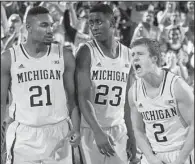  ?? AP/TONY DING ?? Michigan guard Spike Albrecht (2) celebrates with teammates Zak Irvin and Caris LeVert during a second-half timeout in the No. 17 Wolverines’ 68-65 victory over Syracuse on Tuesday in Ann Arbor, Mich.