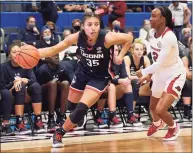  ?? Jessica Hill / Associated Press ?? UConn’s Azzi Fudd, left, is defended by Arkansas’ Samara Spencer on Nov. 14. Fudd will play in her fourth game since Nov. 22 on Sunday.