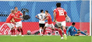  ??  ?? Russia’s midfielder Denis Cheryshev (third right) scores during the World Cup Group A football match between Russia and Egypt at the Saint Petersburg Stadium in Saint Petersburg. — AFP photo