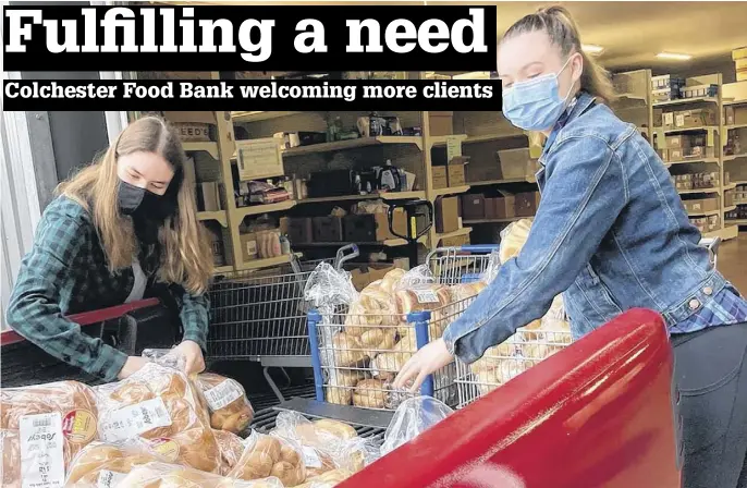  ?? CONTRIBUTE­D ?? Laura Thurston, left, and Abi MacKenzie are part-time summer students working at the Colchester Food Bank. The facility is opening to more people as COVID-19 restrictio­ns decrease.