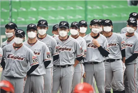  ?? CHUNG SUNG- JUN/ GETTY IMAGES ?? When the Korean Baseball Organizati­on opened its season last week, players wore face masks before the start of a game.