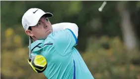  ?? GLYN KIRK/AFP/Getty Images ?? Rory McIlroy watches his drive from the 13th tee during the first round of the PGA Championsh­ip at Wentworth Golf Club in Surrey, England, on Thursday.