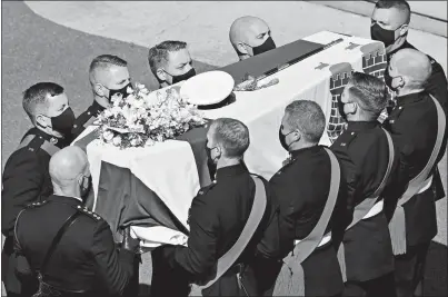  ?? JUSTIN TALLIS POOL VIA AP ?? Pallbearer­s carry the coffin as they arrive at St. George’s Chapel on Saturday for the funeral of Britain’s Prince Philip inside Windsor Castle in Windsor, England. Prince Philip died
April 9 at the age of 99 after 73 years of marriage to Britain’s Queen Elizabeth II.