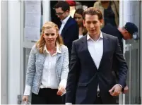  ?? (Leonard Foeger/Reuters) ?? TOP CANDIDATE of the Austrian People’s Party, Foreign Minister Sebastian Kurz, leaves a polling station with his girlfriend, Susanne Thier, in Vienna yesterday.