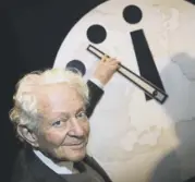  ??  ?? Leon Lederman with the atomic scientists’ ‘Doomsday Clock’ in 2002