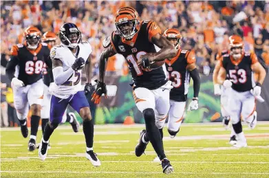  ?? FRANK VICTORES/ASSOCIATED PRESS ?? Cincinnati’s A.J. Green (18) runs for a touchdown during the first half of the Bengals’ win over the Ravens Thursday.