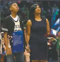  ?? (File Photo/AP/Robert Franklin) ?? Ivey (right) stands with her son Jaden Ivey during her induction into the Notre Dame Ring of Honor before a 2016 game in South Bend, Ind.