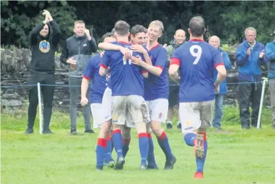  ??  ?? ● Bangor 1876 players celebrate a goal in their win over Ogwen Tigers Picture: Kevin Owen