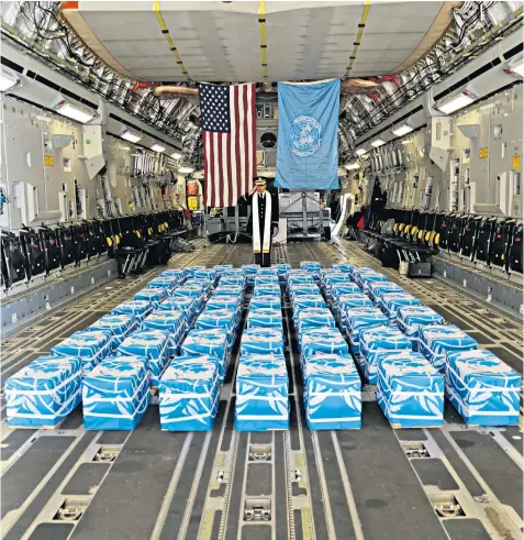  ??  ?? United Nations Command Chaplain US Army Col Sam Lee performs a blessing of sacrifice and remembranc­e on the 55 cases of remains returned by North Korea at Osan Air Base