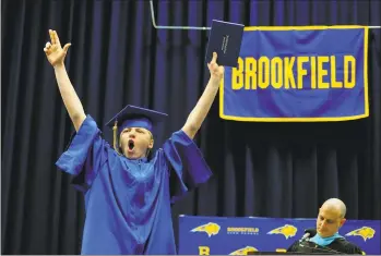  ?? Christian Abraham / Hearst Connecticu­t Media ?? Graduate Tanner Carlson cheers after receiving his diploma during Brookfield High School’s 53rd Commenceme­nt Exercises at at the O’Neill Center at Western Connecticu­t State University in Danbury last year. The state said the Class of 2019 had the best on-time graduation rates in a decade.