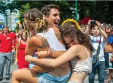  ?? R. JEANETTE MARTIN/TORONTO STAR FILE PHOTO ?? Justin Trudeau is mobbed by women at the Vancouver Pride parade.