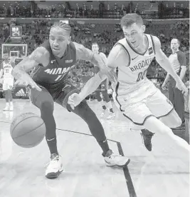  ?? GASTON DE CARDENAS/AP ?? Heat coach Erik Spoelstra on Rodney McGruder, left: “He’s been playing well for two or three weeks, and really making an impression and ... an impact for us in a positive way.”