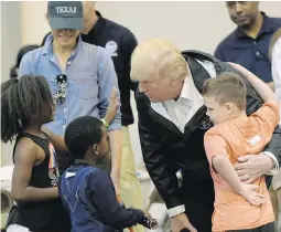  ??  ?? US. President Donald Trump and first lady Melania Trump meet people affected by Harvey during a visit Saturday to the NRG Center, an emergency refuge housing about 1,800 evacuees in Houston.