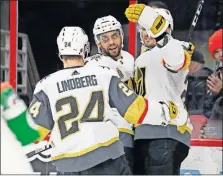  ?? PRESS] [KARL B DEBLAKER/THE ASSOCIATED ?? Golden Knights’ Pierre-Edouard Bellemare (center) celebrates his goal against the Carolina Hurricanes with teammates William Carrier, right, and Oscar Lindberg during the first period Sunday in Raleigh, N.C.