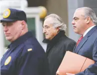  ?? DANIEL ACKER / BLOOMBERG FILES ?? The financial damage done by Bernard Madoff, centre, continues to this day, say victims of his Ponzi-style fraud.