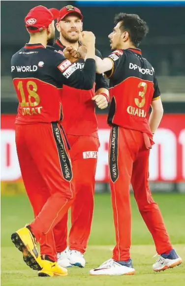  ??  ?? Yuzvendar Chahal (right) celebrates with team-mates after taking the wicket of Jonny Bairstow during their IPL match on Monday.