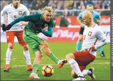  ??  ?? Poland’s Michal Pazdan (right) vies for the ball with Slovenia’s Nik Omladic during yesterday’s internatio­nal friendly in Wroclaw. The game ended 1-1 with Miha Mevlja giving the visitors the lead in the 24th minute only for Lukasz Teodorczyk to...