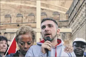  ?? Gregorio Borgia / Associated Press ?? Sex abuse survivor Alessandro Battaglia is hugged by survivor and founding member of Ending Clergy Abuse Denise Buchanan as he speaks during a twilight vigil near Castle Sant’ Angelo in Rome Thursday. Pope Francis opened an abuse prevention summit warning senior Catholics the faithful demand concrete action against predator priests.