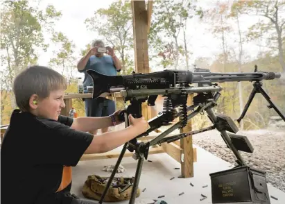 ?? SPENCER PLATT/GETTY IMAGES ?? A young boy shoots an AR-15 rifle during the “Rod of Iron Freedom Festival” in 2019 in Greeley, Pennsylvan­ia. The event billed itself as a “Second Amendment rally and celebratio­n of freedom, faith and family.”