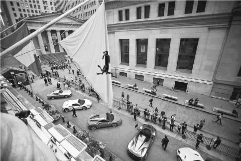  ??  ?? Ferraris sit parked in front of the New York Stock Exchange in New York on Oct 9. — WP-Bloomberg photo