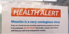  ?? ASSOCIATED PRESS ?? A notice for a health alert about measles is posted on the door of a medical facility last week in Seattle. A recent measles outbreak has sickened more than 50 people in the Pacific Northwest.