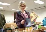  ?? CITIZEN PHOTO BY JAMES DOYLE ?? Annice Yeoman flips through a book at the Friends of the Library Book Sale on Saturday.