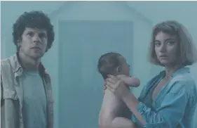  ?? MONGREL MEDIA ?? Jesse Eisenberg, left, and Imogen Poots play a couple who find a baby on their doorstep in the new movie Vivarium.