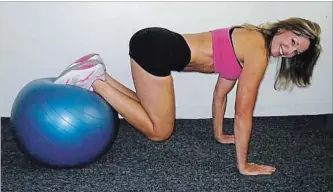  ??  ?? Your upper body should not move. Focus on keeping your balance as you roll the stability ball toward you.