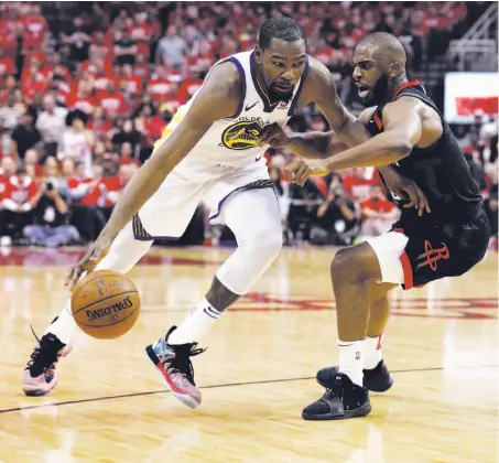  ?? Photos by Carlos Avila Gonzalez / The Chronicle ?? Warriors forward Kevin Durant (35) drives while defended by Rockets guard Chris Paul, who’s all of 6 feet, during the first half.