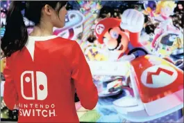  ?? PHOTO: REUTERS ?? An event employee of Nintendo attends the presentati­on ceremony of its new game console Switch in Tokyo, Japan, in January. Anaemic sales worry the company.