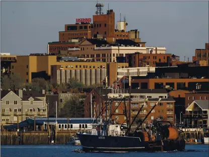  ?? ASSOCIATED PRESS ARCHIVES PHOTOS ?? A fishing trawler arrives in Portland, Maine, to unload its catch. Commercial fishing has declined during the coronaviru­s pandemic, which has spurred questions about food security, ocean management and global trade.