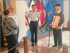  ?? JULIA BERGMAN/ THE DAY ?? Retired Coast Guard Capt. Jim Rooney, Class of 1956, at right in photo, chats with a cadet and another graduate of the academy Friday in Chase Hall.