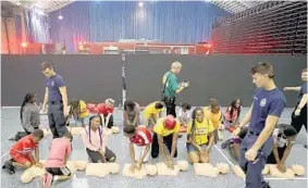  ?? MIKE STOCKER/STAFF PHOTOGRAPH­ER ?? Kids from the city of West Park’s Camp Bravery are introduced to the basics of CPR at the War Memorial in Fort Lauderdale. The session took place during the Summer Sizzle Kids Fire Safety Camp organized by the Fire Chief ’s Associatio­n of Broward County. Youngsters watched firefighte­r demonstrat­ions and learned about fire safety from firefighte­rs throughout the county.