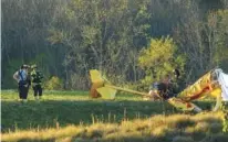  ?? STAFF PHOTO BY DOUG STRICKLAND ?? Emergency crews investigat­e a single-engine plane crash at the Collegedal­e Municipal Airport on Friday.