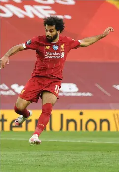  ??  ?? Sharp-shooter: Mo Salah scores Liverpool’s second goal against Crystal Palace at Anfield last night