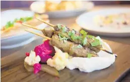  ?? PIPER JONES/COURTESY ?? The new Driftwood in Boynton Beach pairs spiced lamb skewers with whipped goat cheese and pickled vegetables.