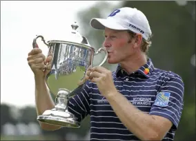  ?? CHUCK BURTON — THE ASSOCIATED PRESS ?? In this file photo, Brandt Snedeker kisses the trophy after winning the Wyndham Championsh­ip golf tournament at Sedgefield Country Club in Greensboro, N.C.