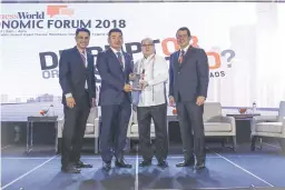  ??  ?? UDENNA Corp. President and Chief Executive Officer (CEO) Dennis A. Uy (second from the left) receives a plaque of appreciati­on from PLDT, Inc. Chairman Manuel V. Pangilinan (second from the right), flanked by BusinessWo­rld President/CEO Miguel G. Belmonte (right) and Editor-in-Chief Roby Alampay (left) at the BusinessWo­rld Economic Forum 2018 in Grand Hyatt Manila, Taguig City.