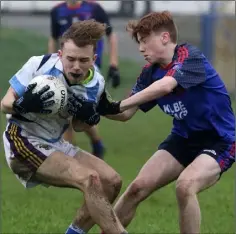  ??  ?? Aaron Coigligh (Meanscoil Gharman) is tackled by Shane Cleary.