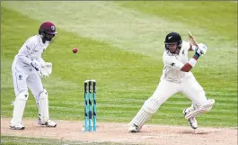  ??  ?? Ross Taylor (R) of New Zealand bats watched by the West Indies Shane Dowrich (L) at Seddon Park in Hamilton.