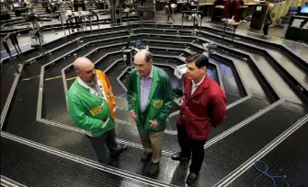  ?? Jim Young/Reuters ?? Thomas J. Cashman, center, is joined by his two sons Thomas F. Cashman, left, and Brendon Eugene Cashman on the Chicago Board of Trade grain trading floor.