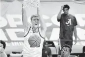  ?? MICHAEL WOODS AP ?? Arkansas forward Connor Vanover (23) dunks over Alabama forward Juwan Gary during the first half.