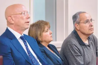  ?? EDDIE MOORE/JOURNAL ?? Former state Taxation and Revenue Secretary Demesia Padilla sits with her attorney, Paul Kennedy, left, and her husband, Jessie Medina Jr., during her arraignmen­t Friday in state District Court in Santa Fe.