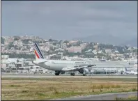  ?? (Bloomberg News (WPNS)/Jeremy Suyker) ?? A passenger aircraft operated by Air France-KLM taxis on the runway at Nice Cote d’Azur Airport in France in February. The carrier obtained a $4.7 billion bailout last week, giving the French government a stake of up to 30%.
