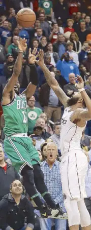  ??  ?? Boston Celtics guard Kyrie Irving is fouled by Washington Wizards forward Markieff Morris as he takes a jumper in their NBA game in Washington. AP