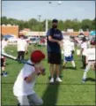  ?? MICHAEL JOHNSON — THE NEWS-HERALD ?? Corey Kluber pitches wiffle balls to campers during his baseball camp at Mentor High School on June 21.