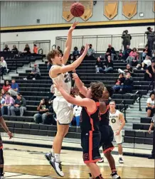  ?? TIM GODBEE / For the Calhoun Times ?? Calhoun’s Davis Allen (left) shoots over Hart County’s Tyler Dalton during the first half on Saturday.