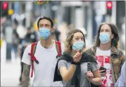  ?? FRANK AUGSTEIN - THE ASSOCIATED PRESS ?? Shoppers wearing protective face masks walk along Oxford Street in London, Tuesday, July 14.Britain’s government is demanding people wear face coverings in shops as it has sought to clarify its message after weeks of prevaricat­ion amid the COVID-19 pandemic.