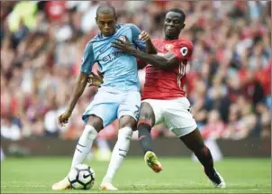  ?? OLI SCARFF/AFP ?? Manchester City’s Brazilian midfielder Fernandinh­o (left) challenges Manchester United’s Ivorian defender Eric Bailly during an English Premier League match at Old Trafford, Manchester, on September 10.